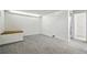 A finished basement area with carpet and a small wooden bench at 7065 Ingalls Ct, Arvada, CO 80003