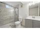 Finished basement bathroom with tiled shower, gray vanity, and modern finishes at 7065 Ingalls Ct, Arvada, CO 80003