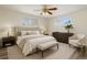 Bright bedroom with a comfortable bed, two windows, modern furniture, and neutral decor at 7065 Ingalls Ct, Arvada, CO 80003