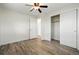 This bedroom has gray wood floors, a ceiling fan with light, and a closet at 7065 Ingalls Ct, Arvada, CO 80003