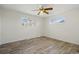 Bright bedroom featuring two windows and hardwood floors at 7065 Ingalls Ct, Arvada, CO 80003
