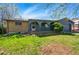 Charming single-story home featuring a blue exterior, arched doorway, and a well-maintained front yard at 7065 Ingalls Ct, Arvada, CO 80003