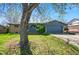 Charming single-story home featuring a blue exterior, arched doorway, and a two-car garage at 7065 Ingalls Ct, Arvada, CO 80003
