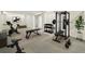 Spacious home gym with exercise equipment including a bike, weights, and weight lifting rack at 7065 Ingalls Ct, Arvada, CO 80003