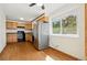 Updated kitchen featuring stainless steel appliances, wooden cabinets, and wood floors at 7065 Ingalls Ct, Arvada, CO 80003