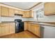 Updated kitchen featuring light wood cabinets, stainless steel appliances, and hardwood floors at 7065 Ingalls Ct, Arvada, CO 80003