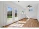 Bright living room featuring French doors and a ceiling fan at 7065 Ingalls Ct, Arvada, CO 80003
