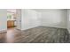 Bright living room featuring neutral walls and wood-look floors, with access to the kitchen at 7065 Ingalls Ct, Arvada, CO 80003
