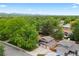 Aerial shot of a suburban home surrounded by mature trees and lush greenery at 9043 W Warren Dr, Lakewood, CO 80227