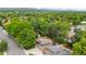 Aerial view of a property surrounded by mature trees in a quiet neighborhood at 9043 W Warren Dr, Lakewood, CO 80227