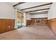 A wood paneled living room featuring a brick fireplace and sliding doors to the backyard at 9043 W Warren Dr, Lakewood, CO 80227