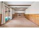 Wood paneled living room featuring a brick fireplace and sliding glass doors at 9043 W Warren Dr, Lakewood, CO 80227