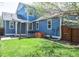 Beautiful backyard with patio furniture, manicured lawn, and a garden bed at 3171 Fulton St, Denver, CO 80238