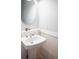 Cozy half-bathroom with pedestal sink, modern fixtures, and stylish wainscotting at 3171 Fulton St, Denver, CO 80238