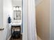 Bathroom featuring modern vanity with storage and a tiled shower at 3171 Fulton St, Denver, CO 80238