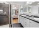 Bathroom with dual sinks, modern vanity, and step-in shower at 3171 Fulton St, Denver, CO 80238