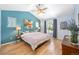 Comfortable main bedroom featuring a vaulted ceiling and calming blue accent wall at 3171 Fulton St, Denver, CO 80238