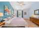 Comfortable main bedroom featuring a vaulted ceiling and calming blue accent wall at 3171 Fulton St, Denver, CO 80238
