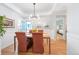Elegant dining room with modern chandelier, hardwood floors, and views into other living spaces at 3171 Fulton St, Denver, CO 80238