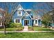 Charming blue two-story home with white trim, manicured lawn, and mature trees at 3171 Fulton St, Denver, CO 80238