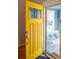 Bright yellow front door, leads to a porch swing visible through a glass storm door at 3171 Fulton St, Denver, CO 80238