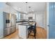 Modern kitchen with stainless steel appliances, white cabinets, and a center island with seating at 3171 Fulton St, Denver, CO 80238