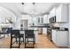 Open kitchen featuring stainless steel appliances, white cabinetry, and a view to the living room at 3171 Fulton St, Denver, CO 80238