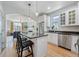 Modern kitchen with stainless steel appliances, white cabinets, island seating, and an open layout at 3171 Fulton St, Denver, CO 80238