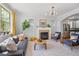 Sunlit living room with a fireplace, hardwood floors, and stylish furniture, creating a cozy atmosphere at 3171 Fulton St, Denver, CO 80238