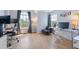 Bright home office features wood floors, large windows, desk, and comfortable seating at 3171 Fulton St, Denver, CO 80238