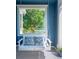 Inviting porch with a white swing and colorful pillows, offering a relaxing outdoor space at 3171 Fulton St, Denver, CO 80238