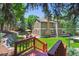 Expansive backyard features lush greenery, patio, and seating areas at 7264 Wembley Pl, Castle Pines, CO 80108