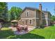 Spacious backyard with patio, outdoor seating, fire pit, and lush lawn at 7264 Wembley Pl, Castle Pines, CO 80108