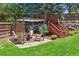 Secluded backyard features patio, seating, and fire pit at 7264 Wembley Pl, Castle Pines, CO 80108