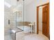 Bright bathroom featuring a walk-in shower with a seat and a separate soaking tub at 7264 Wembley Pl, Castle Pines, CO 80108