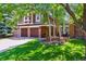 Beautiful two-story home featuring a three-car garage, brick facade, and lush green lawn at 7264 Wembley Pl, Castle Pines, CO 80108