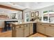 Spacious kitchen features a central island, granite countertops, and modern cabinets at 7264 Wembley Pl, Castle Pines, CO 80108