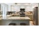 Kitchen with granite countertops, stainless steel appliances, and white cabinets at 7264 Wembley Pl, Castle Pines, CO 80108