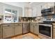 Updated kitchen with granite countertops, stainless steel appliances, and modern cabinetry at 7264 Wembley Pl, Castle Pines, CO 80108