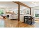 Bright living room features hardwood floors, a fireplace, and a breakfast bar at 7264 Wembley Pl, Castle Pines, CO 80108