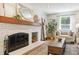 Cozy living room with fireplace, mantel and stylish decor at 7264 Wembley Pl, Castle Pines, CO 80108