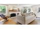 Comfortable living room with a white brick fireplace and hardwood flooring at 7264 Wembley Pl, Castle Pines, CO 80108