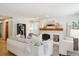Inviting living room with brick fireplace, ample seating, and natural light at 7264 Wembley Pl, Castle Pines, CO 80108
