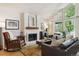 Bright living room features a brick fireplace, vaulted ceilings, and large windows with shutters at 7264 Wembley Pl, Castle Pines, CO 80108