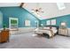 Spacious main bedroom with vaulted ceilings and natural light from skylights at 7264 Wembley Pl, Castle Pines, CO 80108