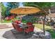Backyard patio with dining table, seating, and umbrella at 7264 Wembley Pl, Castle Pines, CO 80108