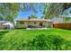 Spacious backyard with lush green lawn, patio area, and seating is perfect for outdoor enjoyment at 1759 Cedar St, Broomfield, CO 80020