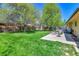 Lush green backyard with a stone patio and outdoor furniture at 1759 Cedar St, Broomfield, CO 80020