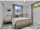 Bedroom with neutral tones, large window, stylish bed frame, and decorative pillows provides a tranquil space at 1759 Cedar St, Broomfield, CO 80020