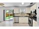 Well-lit kitchen with modern appliances, including stainless steel stove and dishwasher, with backyard access at 1759 Cedar St, Broomfield, CO 80020